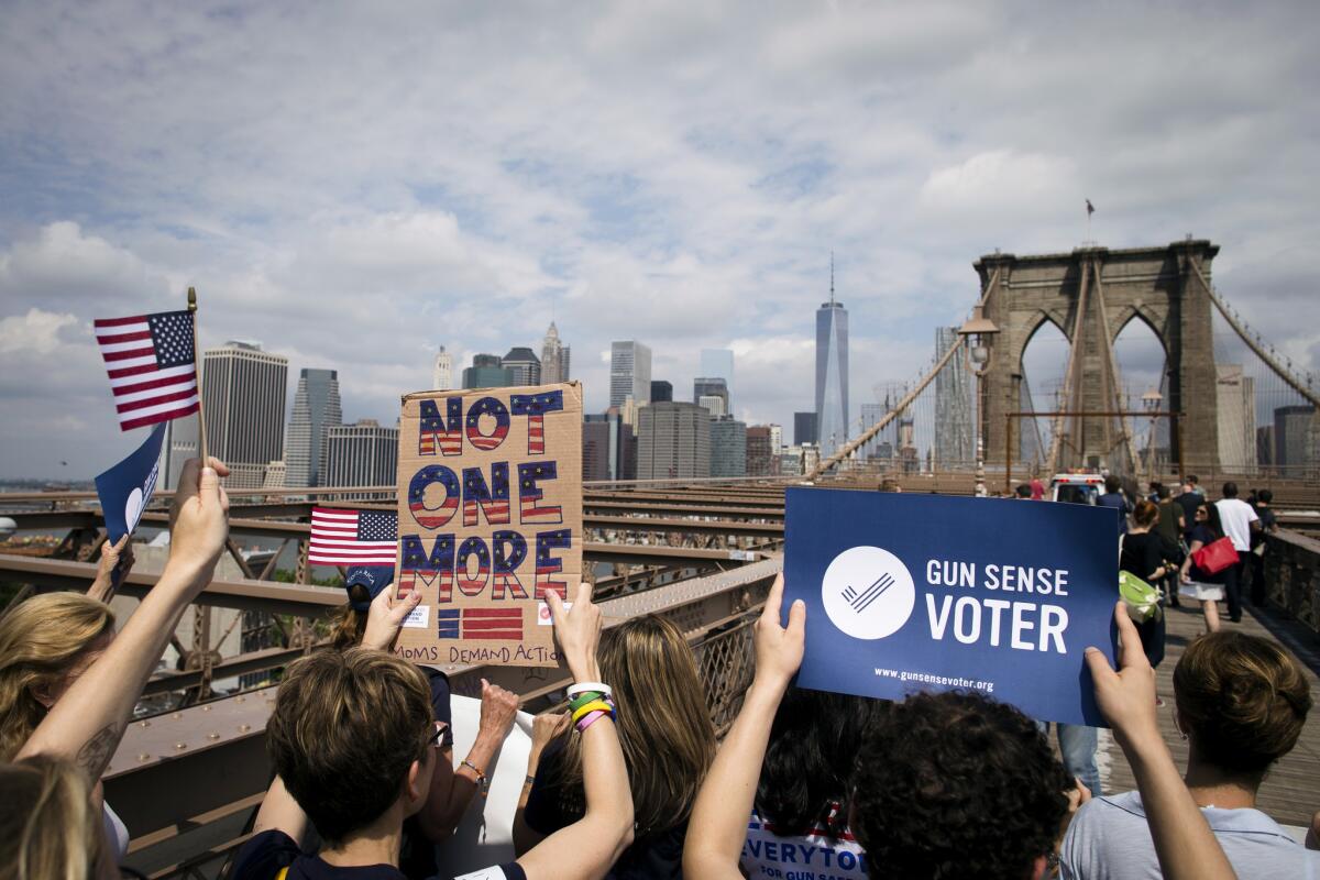 Demonstrators march across the Brooklyn Bridge in New York to call for tougher gun control laws.