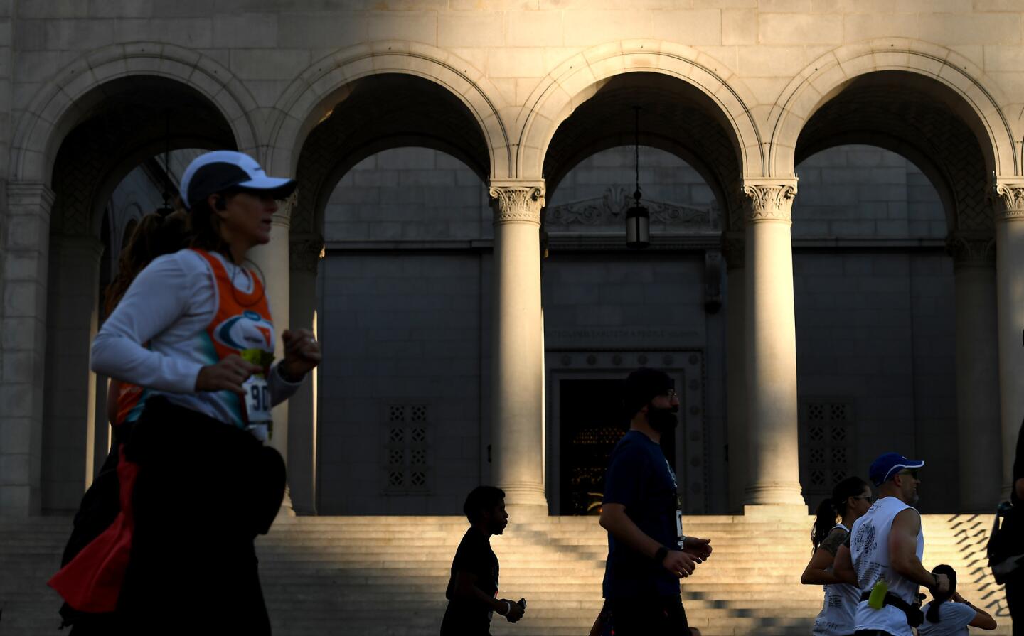 Competitors run past L.A. City Hall during the marathon.