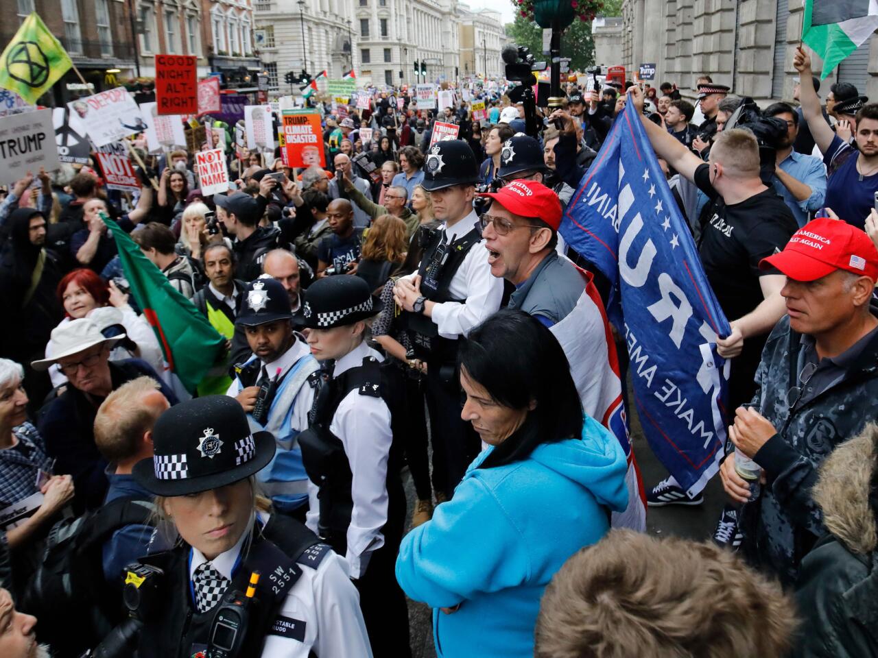 Police form a barrier between pro and anti-Trump protesters along whitehall in London on the second day of Trump's three-day state visit to Britain. -