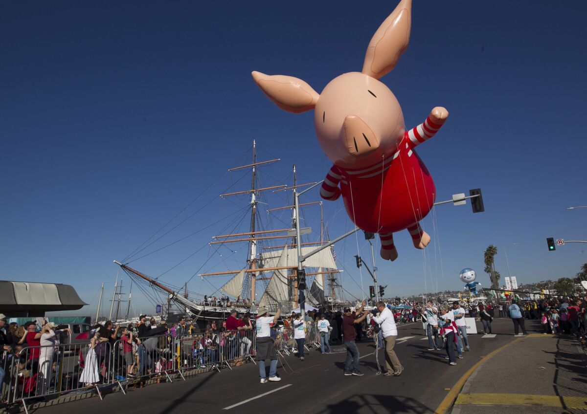 The cartoon character Olivia the pig makes her way down the parade route at the 40th annual Holiday Bowl Parade.