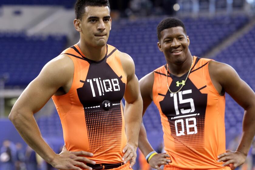 Oregon quarterback Marcus Mariota and Florida State quarterback Jameis Winston wait to run a drill at the NFL scouting combine on Feb. 21.