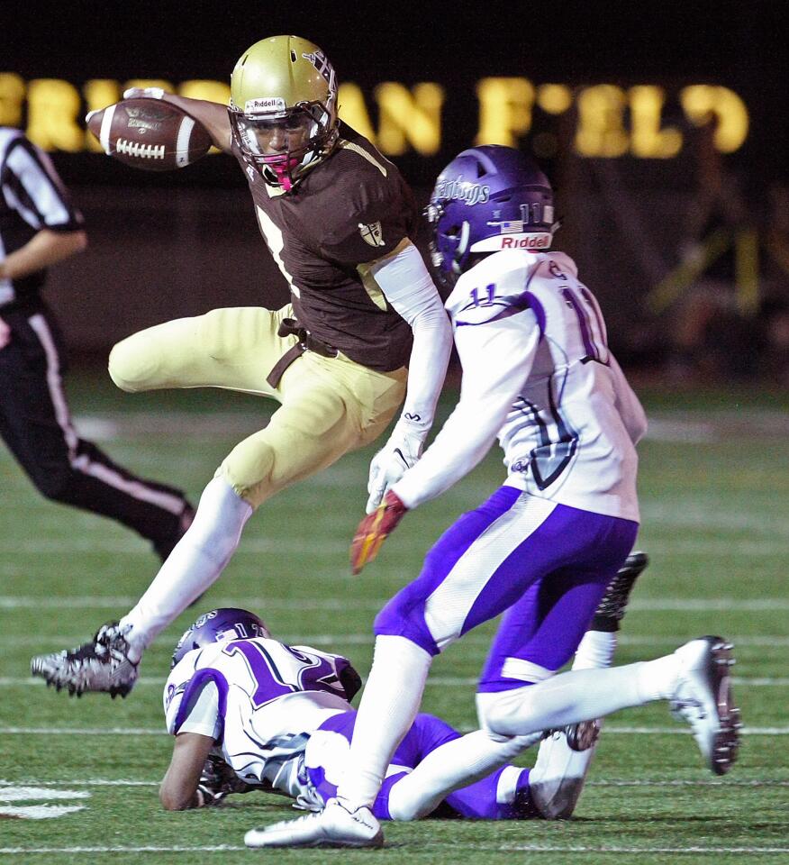 St. Francis' Jasher Foster leaps over Cathedral defender Christian Daniel and evades Renard Bell during a game on Friday, October 23, 2015.
