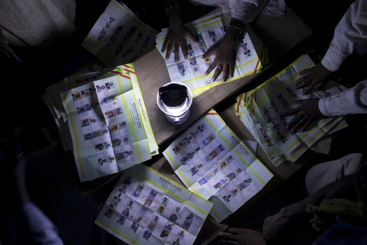 Election workers count votes at a station that reported a high voter turnout in Kidal, Mali, on Sunday.