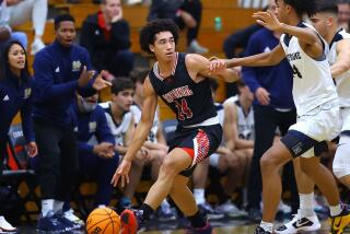 Jared McCain of Corona Centennial dribbles against Sherman Oaks Notre Dame.