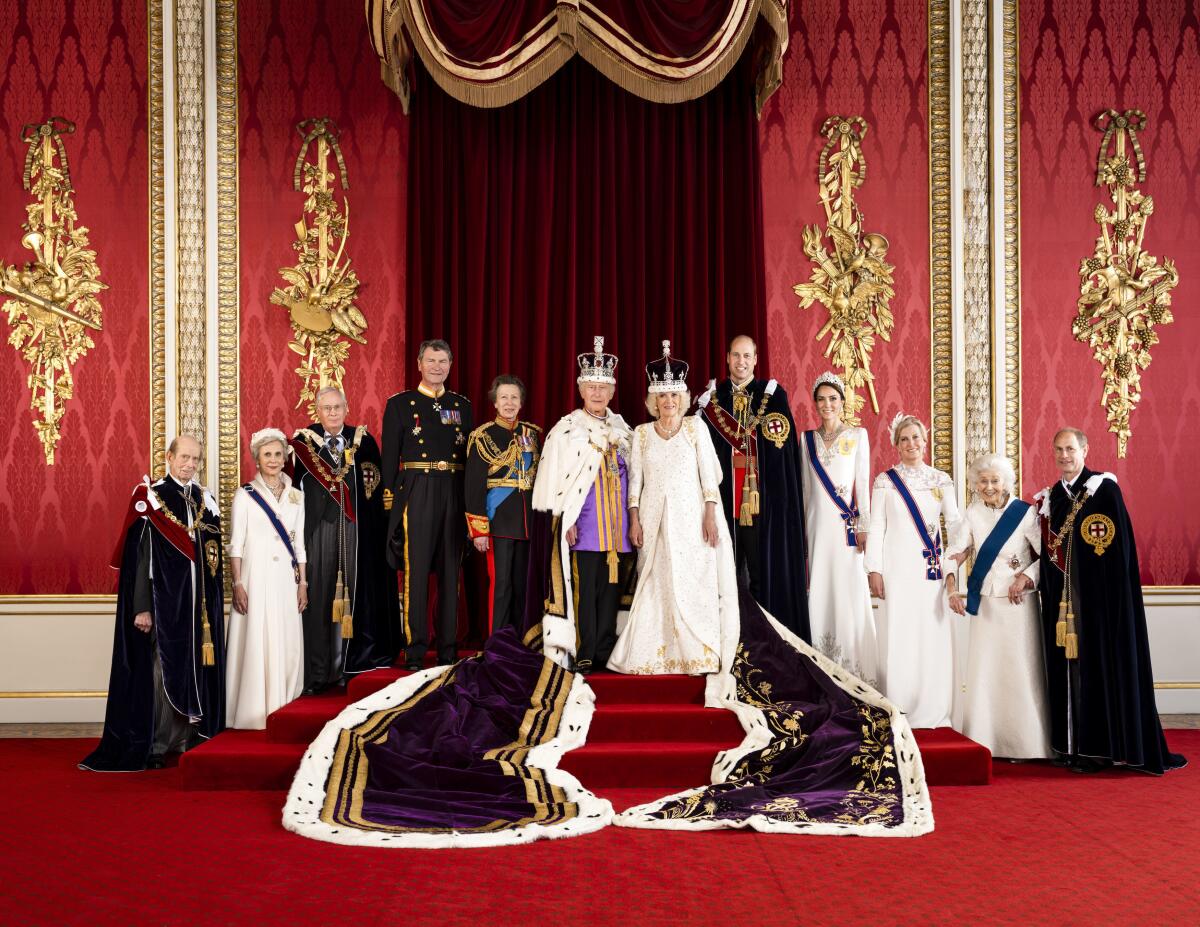King Charles III and Queen Camilla with members of the royal family in the Throne Room of Buckingham Palace in London.