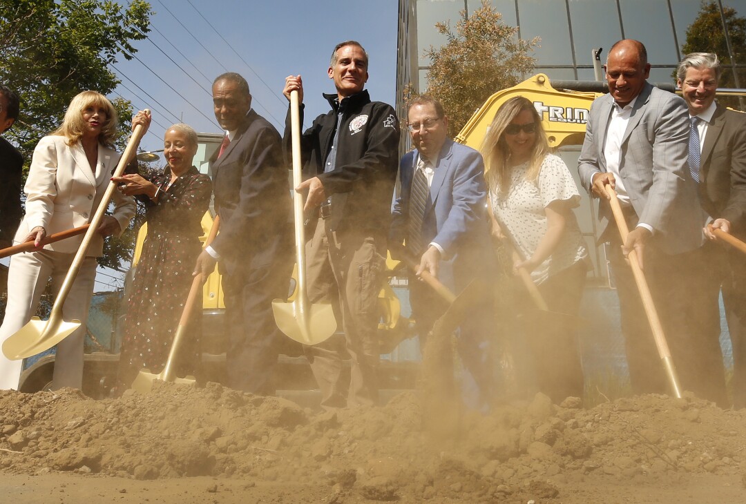Los Angeles Mayor Eric Garcetti and other officials use shovels during a groundbreaking ceremony