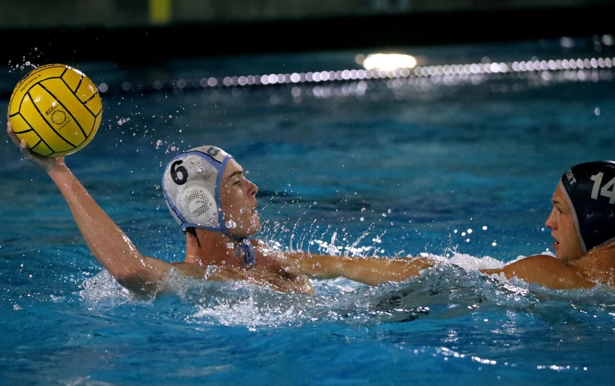 Corona Del Mar High School's Eamon Hennessey (6) looks to pass under pressure in a game vs. Newport Harbor on Thursday.