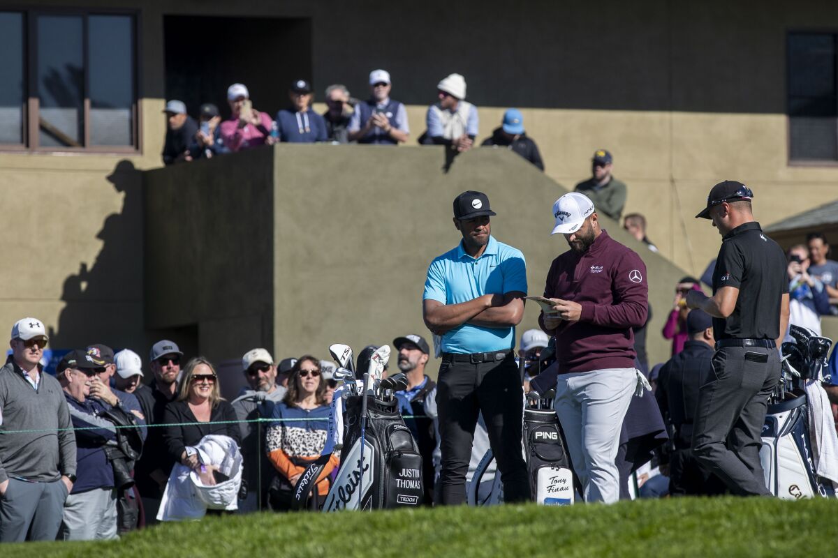 Fans gather to watch (left to right) Tony Finau, Jon Rahm, and Justin Thomas tee off on No. 1 at Torrey Pines' South Course.