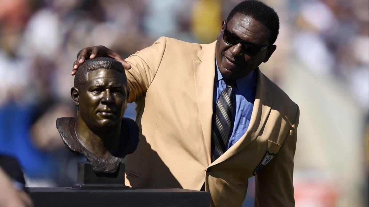 Jackie Slater, looking at his bust during the Rams Hall of Fame Ring of Excellence ceremony in 2016, is caught in the middle for Super Bowl LIII. His son Matthew is a seven-time Pro Bowl player with the Patriots.