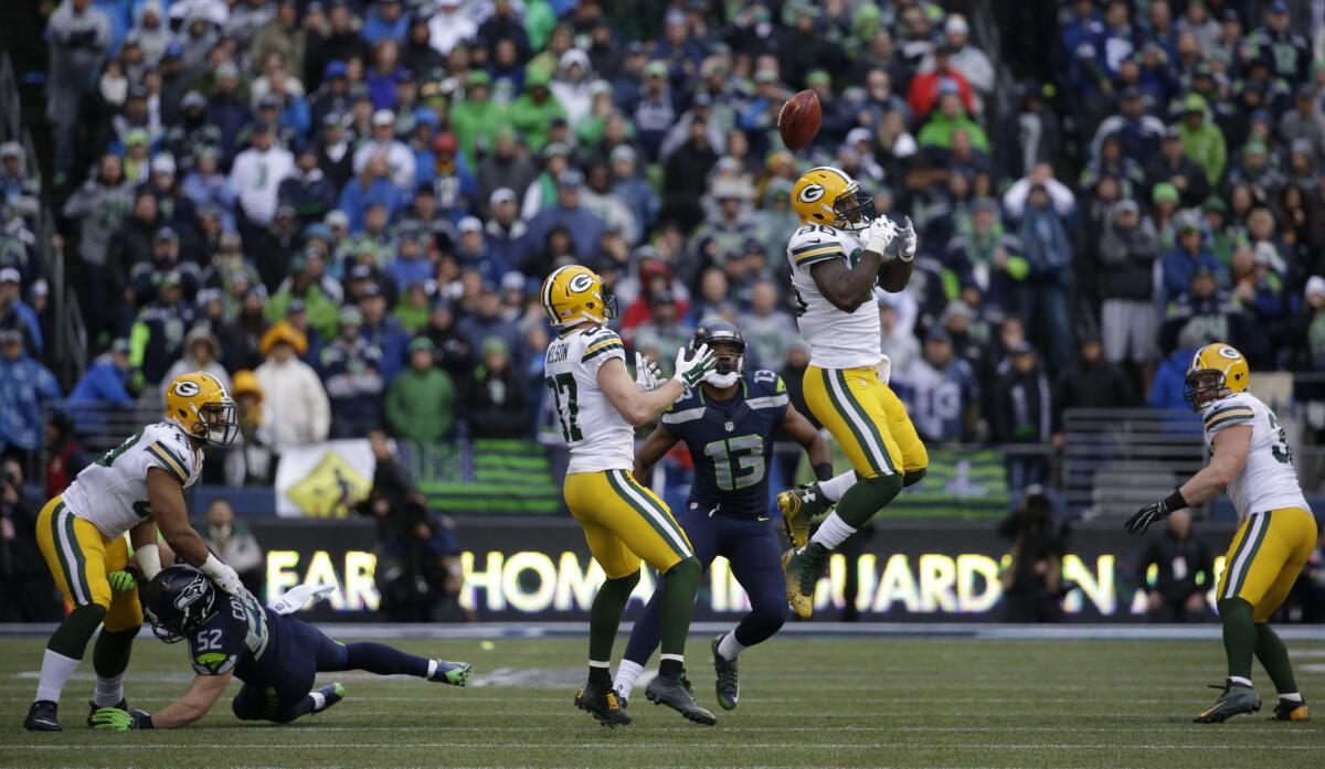 Green Bay's Brandon Bostick misses while reaching for an onside kick from the Seattle Seahawks late the second half of the NFC championship game on Jan. 18.