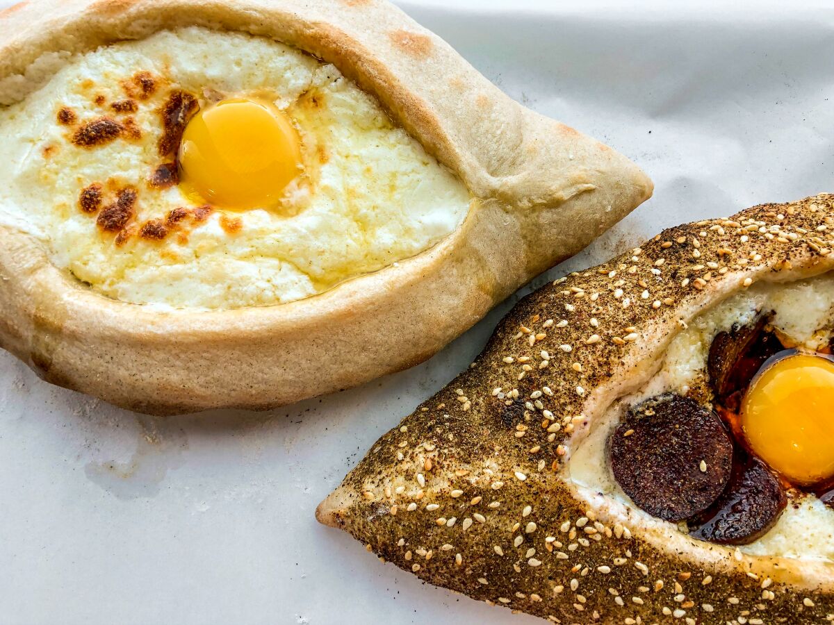 Khachapuris (original, left, and one with sujuk and a za'atar-covered crust) at Tony Khachapuri in Hollywood