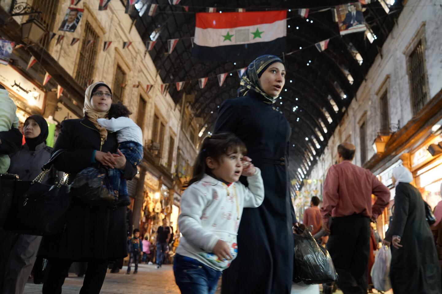 People shop in the Hamidiya souk in Damascus' Old City.