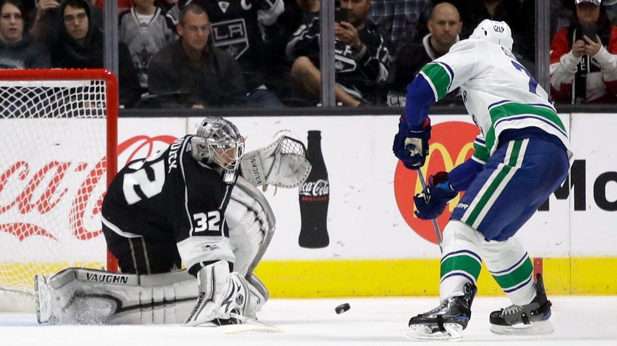 Kings goalie Jonathan Quick, left, blocks a a penalty shot by Vancouver Canucks center Brandon Sutter during the second period on Tuesday.