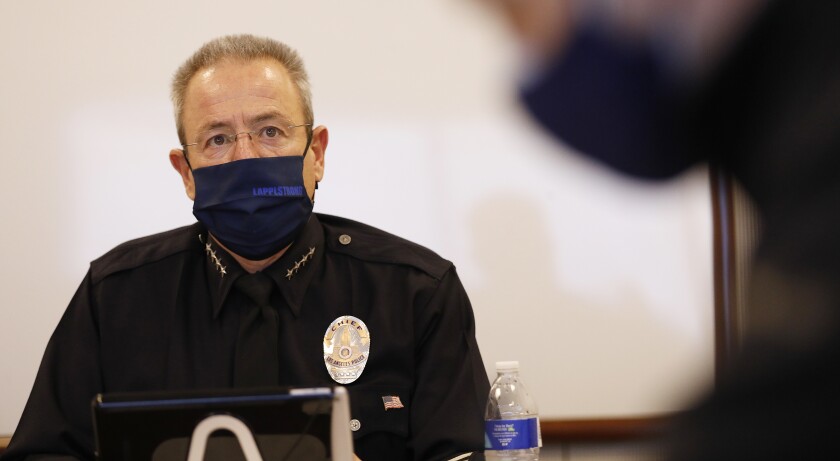 LAPD Chief Michel Moore in a mask.