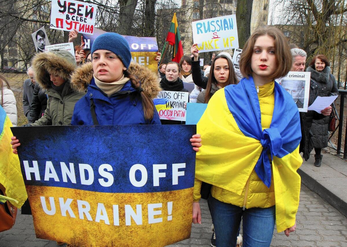 Demonstrators march in front of the Russian Embassy in Vilnius, Lithuania, to protest Russian intervention in Ukraine.
