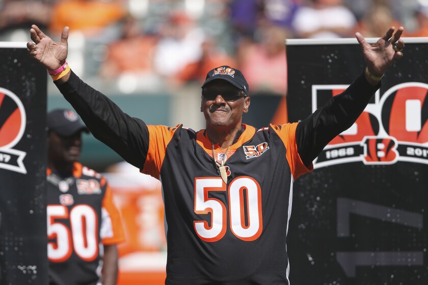 FILE - Former Cincinnati Bengals defensive end Ross Browner waves to the crowd during a halftime ceremony of an NFL football game against the Baltimore Ravens, Sunday, Sept. 10, 2017, in Cincinnati. Browner, a two-time All-American at Notre Dame and one of four brothers who played in the NFL, has died. He was 67. Browner's son, former NFL offensive lineman Max Starks, posted on Twitter early Wednesday morning, Jan. 5, 2022, that his father had died. (AP Photo/Gary Landers, File)