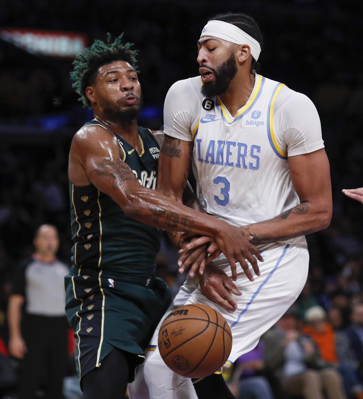 Boston Celtics guard Marcus Smart strips the ball from Lakers forward Anthony Davis.