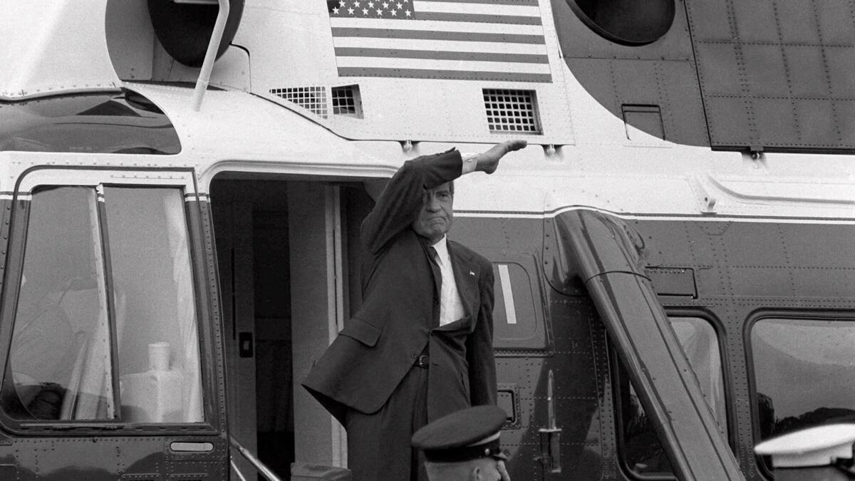 On the day of his resignation, Richard M. Nixon waves goodbye from the steps of his helicopter as he leaves the White House following a farewell address to his staff on Aug. 9, 1974. The Watergate scandal forced Nixon to become the first U.S. president to resign from office.