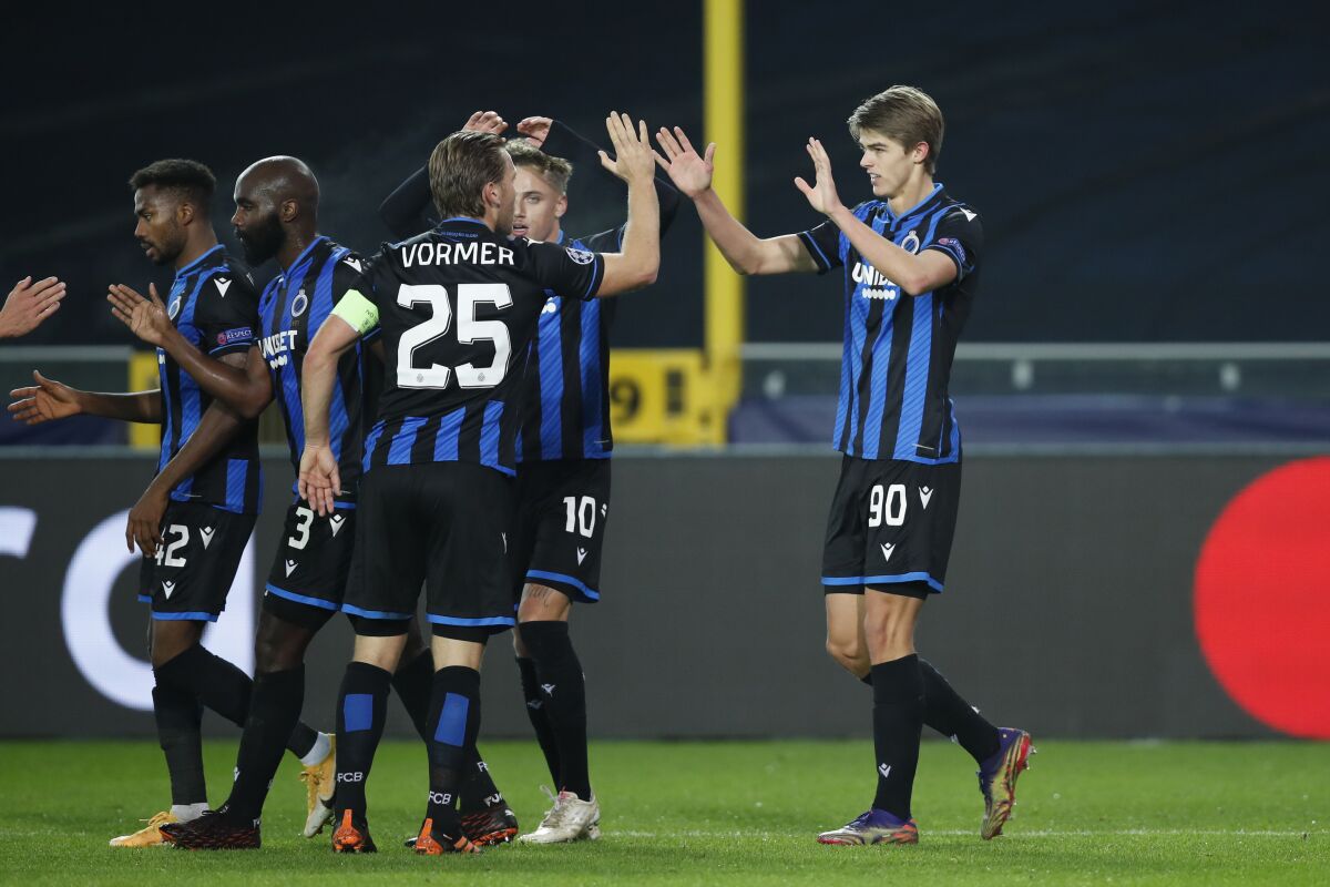 Brugge's Charles De Ketelaere, right, is congratulated after scoring the opening goal of the match during a Champions league Group F soccer match between Brugge and Zenit at the Jan Breydel stadium in Bruges, Belgium, Wednesday, Dec. 2, 2020. (AP Photo/Francisco Seco)