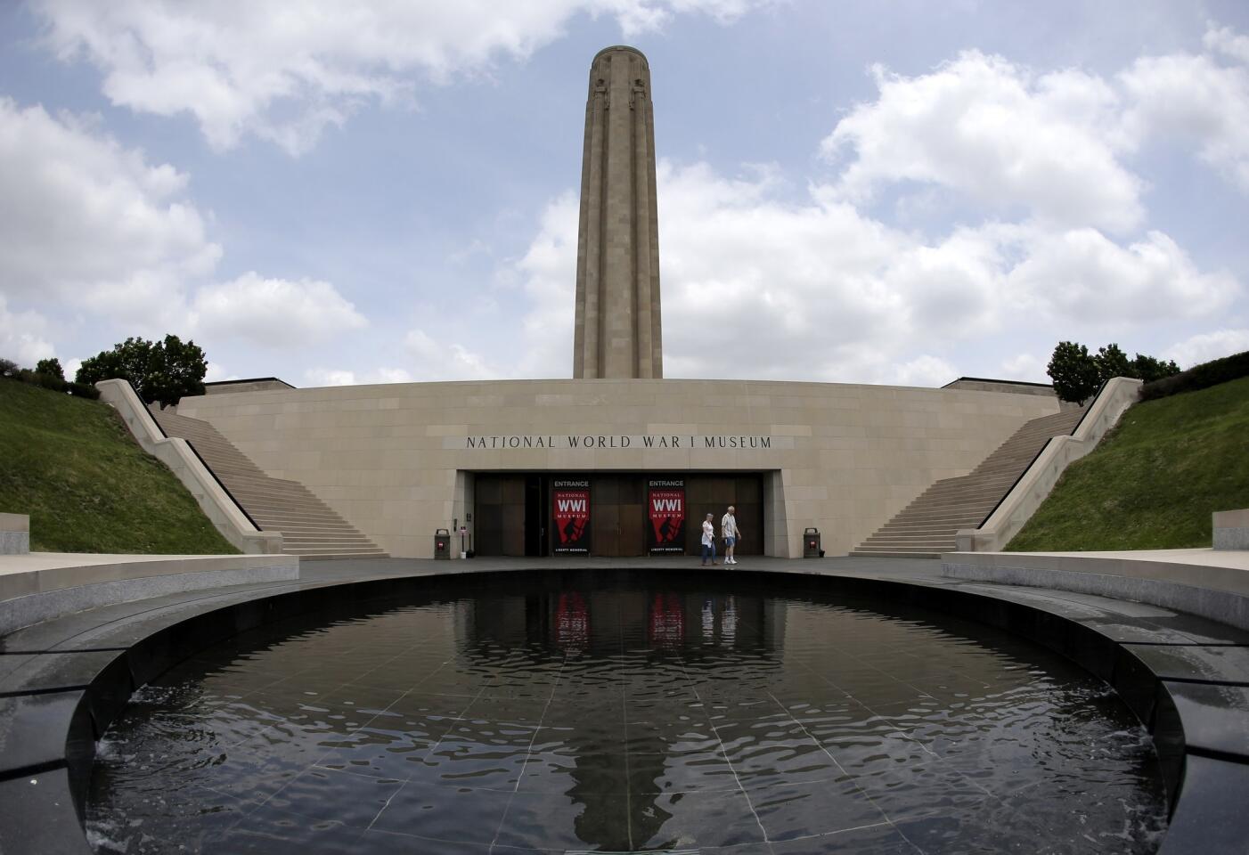 Visitors walk near a reflecting pool outside the main entrance to the National World War I Museum at Liberty Memorial in Kansas City, Mo. The museum focuses on the Great War, which started 100 years ago.