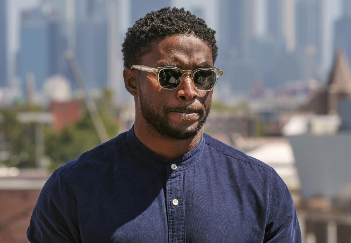 Former USC football player Reggie Bush listens to questions during a news conference at the Coliseum 