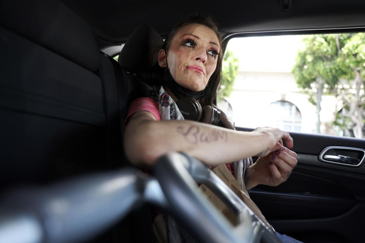 Loretta Elias rides in the back of a Jeep.