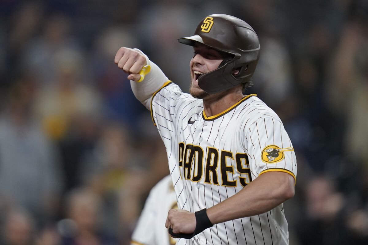 San Diego Padres' Wil Myers celebrates after hitting a home run during the eighth inning of a baseball game against the San Francisco Giants, Tuesday, Oct. 4, 2022, in San Diego. (AP Photo/Gregory Bull)