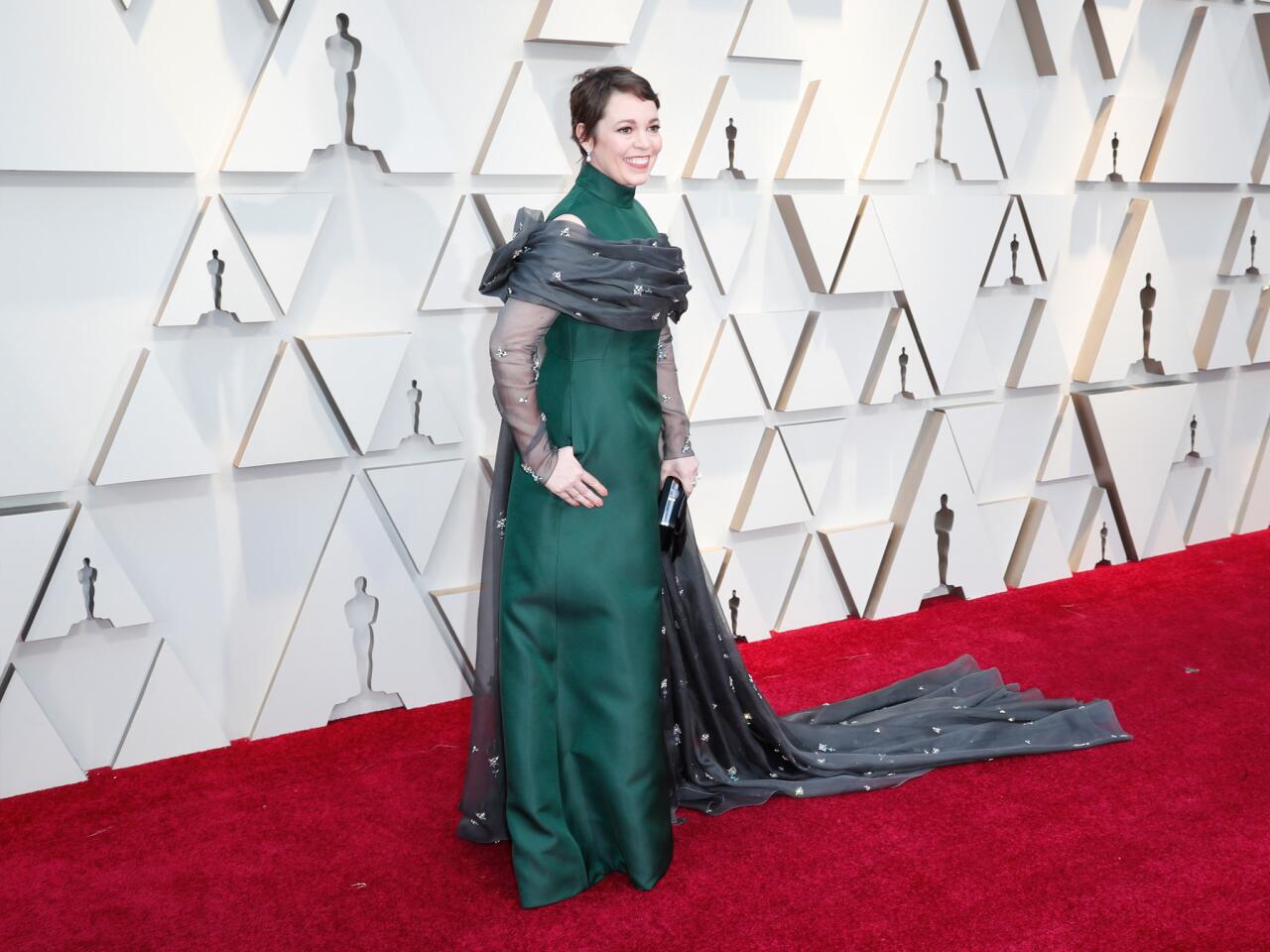 MISS: Olivia Colman looks as if she's a new baby being swaddled, albeit in a gorgeous Prada gown inspired by her stylist's trips through the desert.