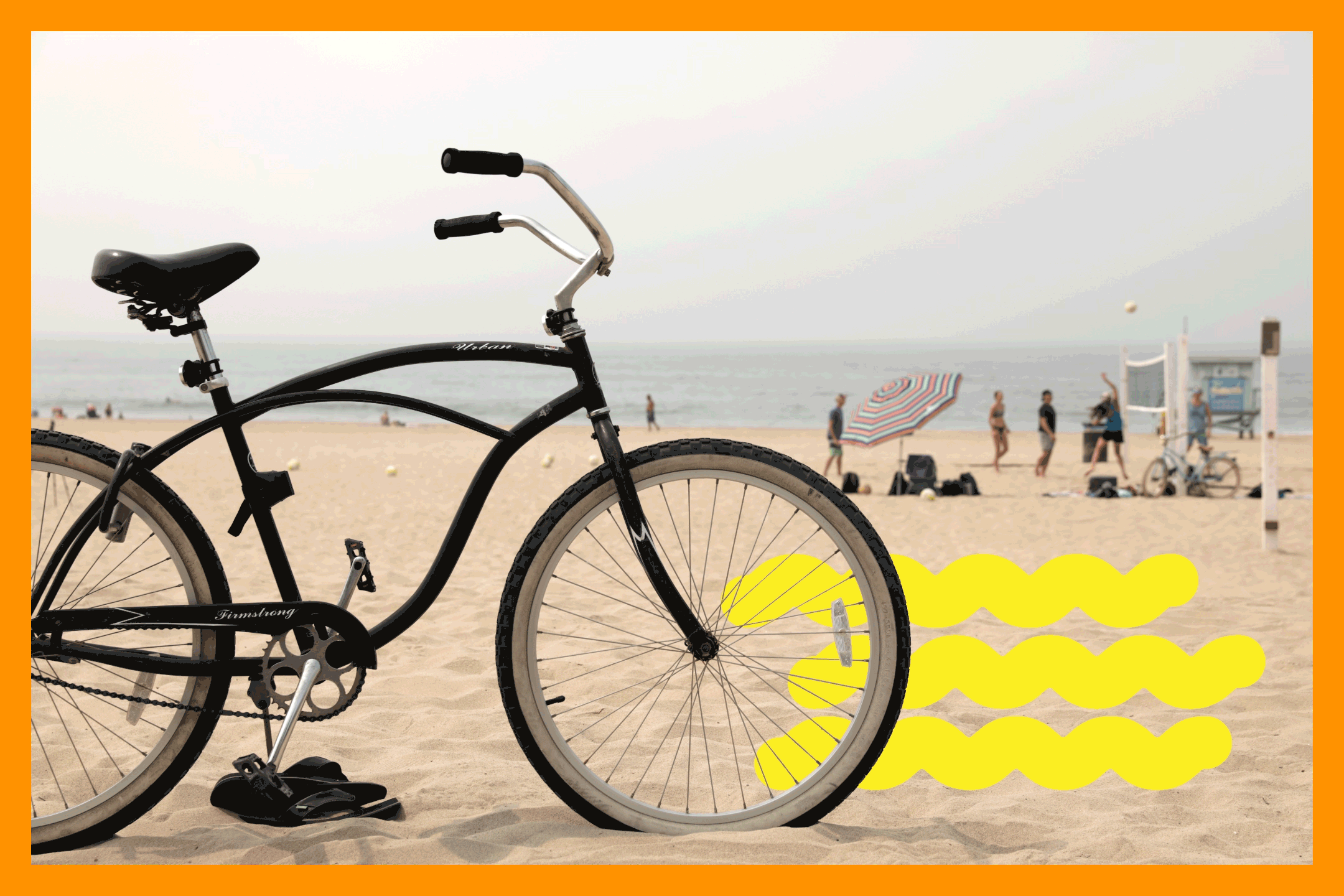 A bike rests in the sand near volleyball courts.