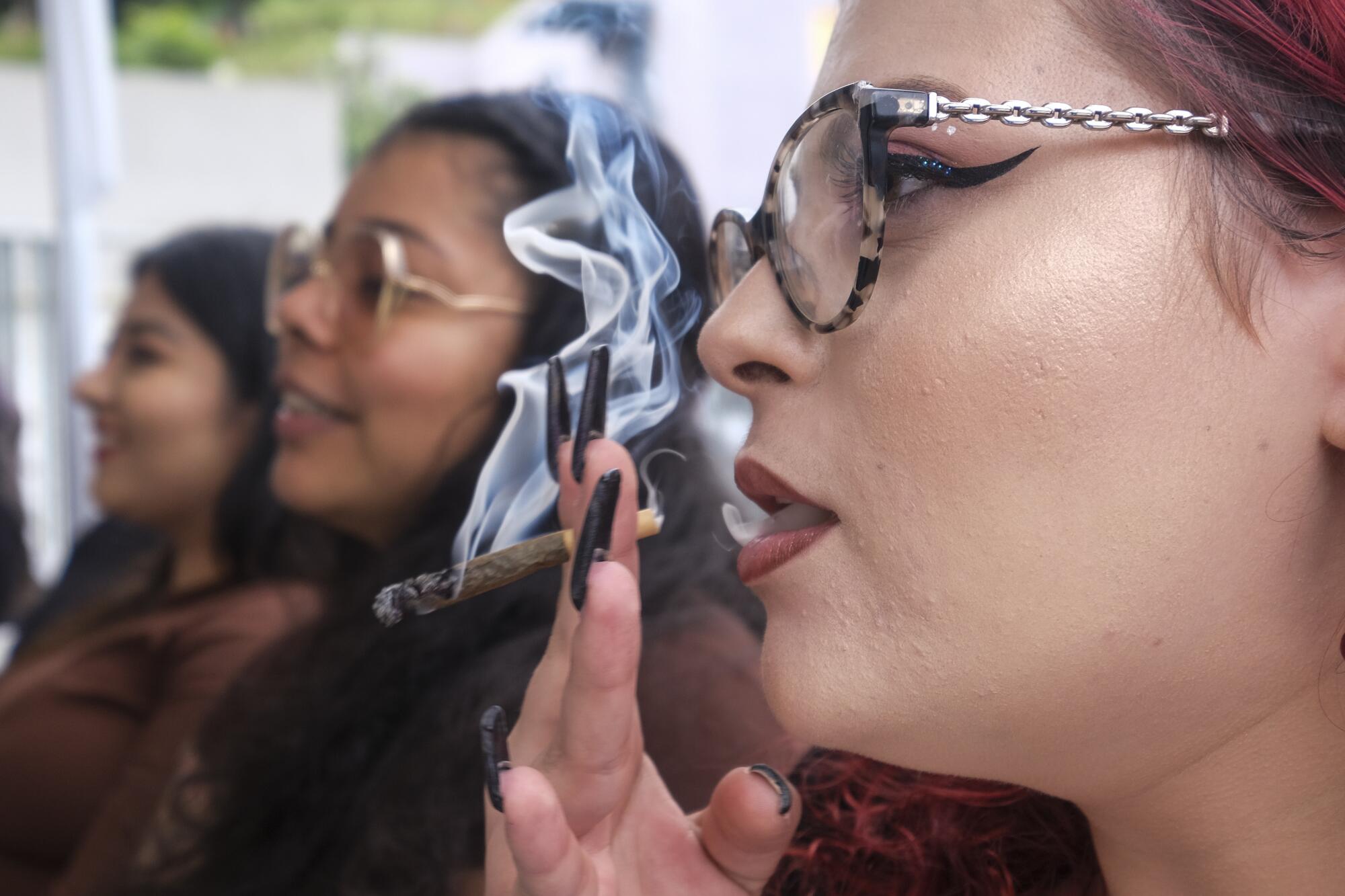 A woman smokes a joint