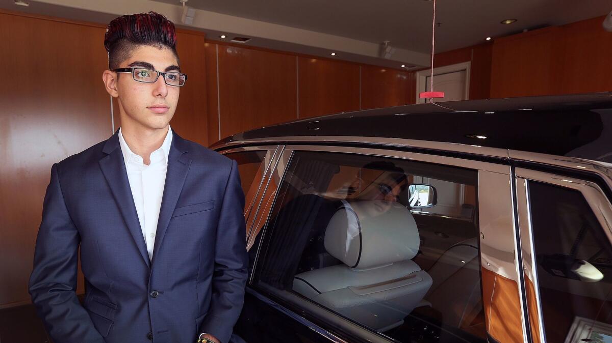 Steven Aghakhani, 14, of La Cañada Flintridge, stands with one of his father's vehicles. Steven currently races Lamborghinis.