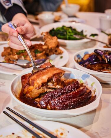 Braised pork belly and other dishes on a table at Golden Soup