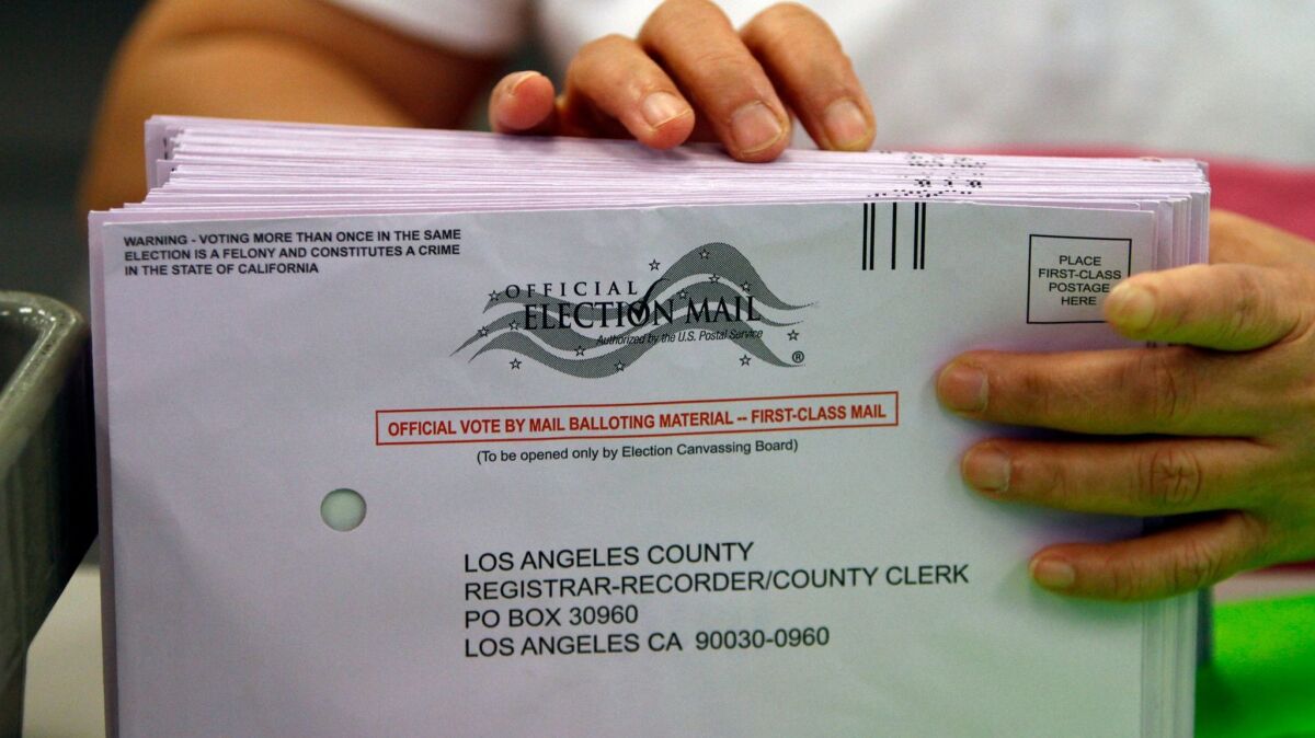 A clerk sorts vote by mail ballots at the Los Angeles county registrar's office in Norwalk.