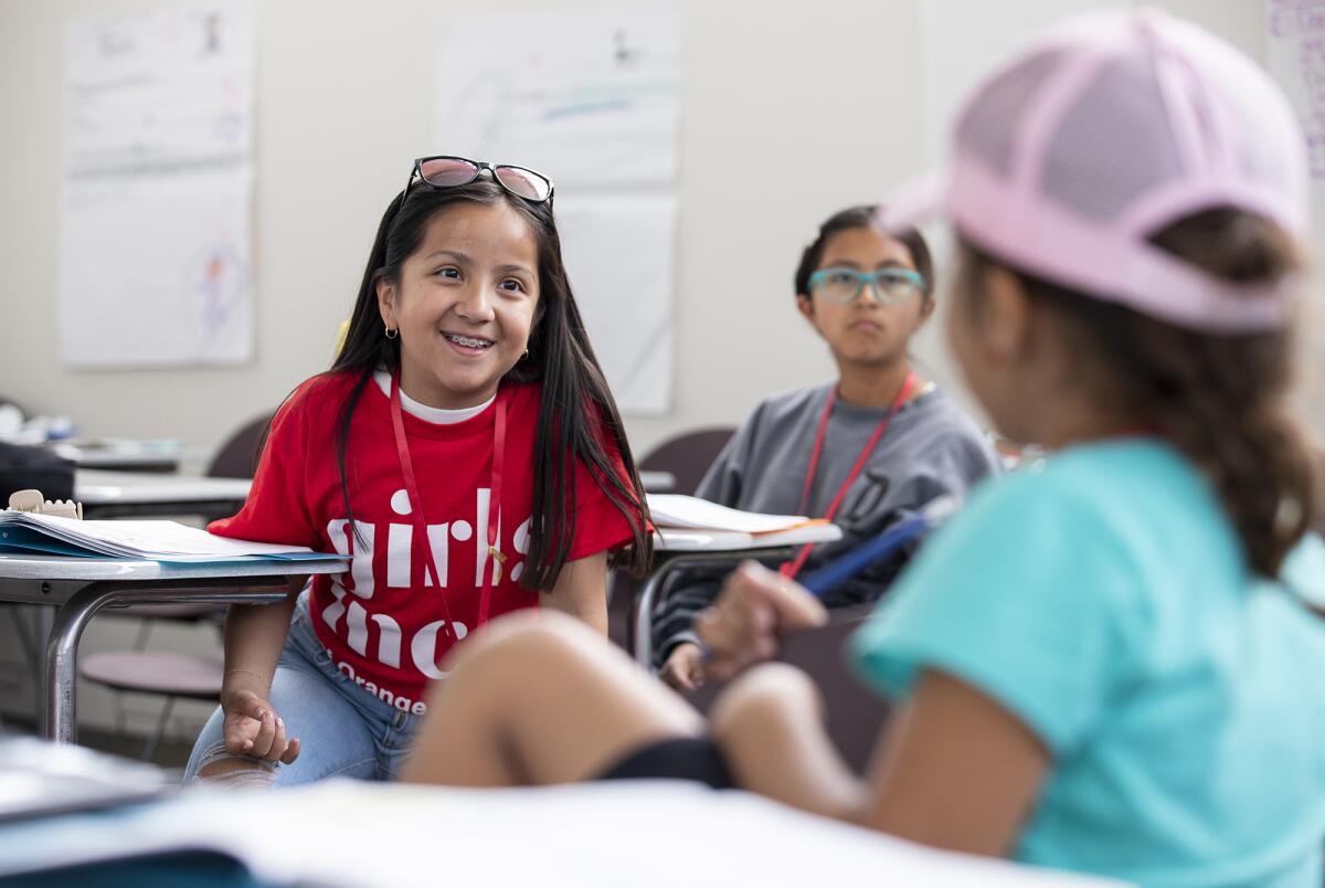 Celeste Nunez-Jurado, 11, left, talk with Yurianna Mendez, 7.