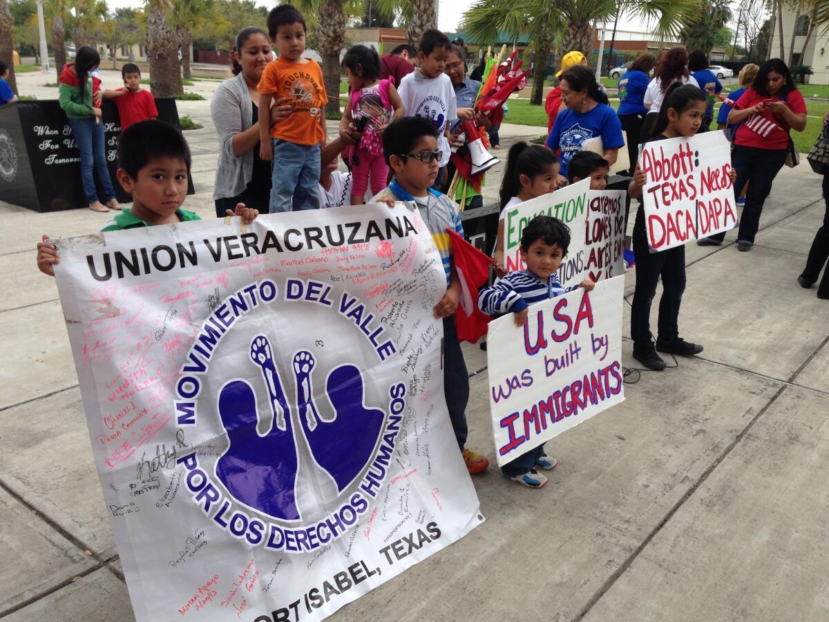 Immigration activists gather Thursday outside a federal courthouse in Brownsville, Texas, for a hearing on President Obama's immigration plan.