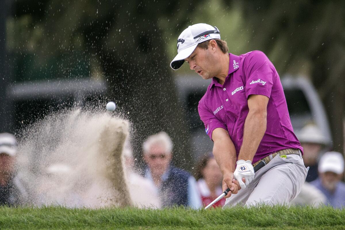 Kevin Kisner hits out of a greenside bunker at No. 15 on Saturday during the third round of the RSM Classic.