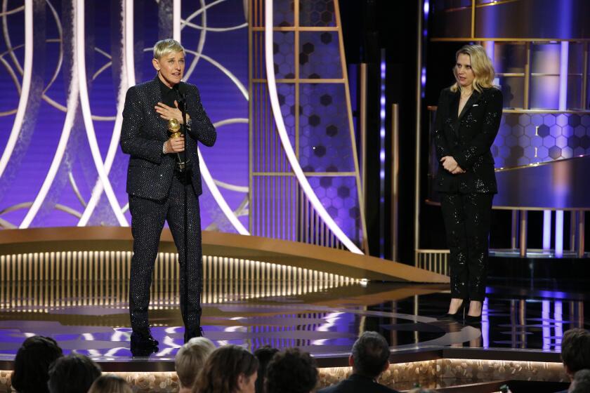 This image released by NBC shows Ellen DeGeneres accepts the Carol Burnett TV Achievement Award as presenter Kate McKinnon, right, looks on at the 77th Annual Golden Globe Awards at the Beverly Hilton Hotel in Beverly Hills, Calif., on Sunday, Jan. 5, 2020. (Paul Drinkwater/NBC via AP)