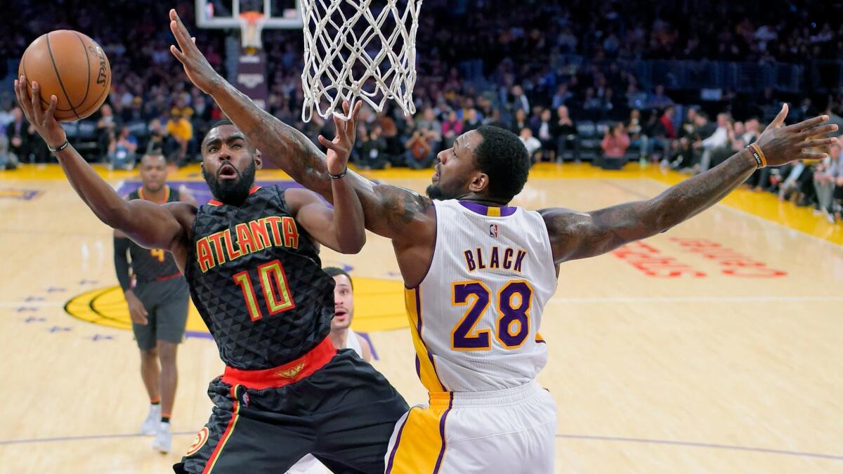 Lakers' Tarik Black, right, defends Atlanta's Tim Hardaway Jr. on Nov. 27.