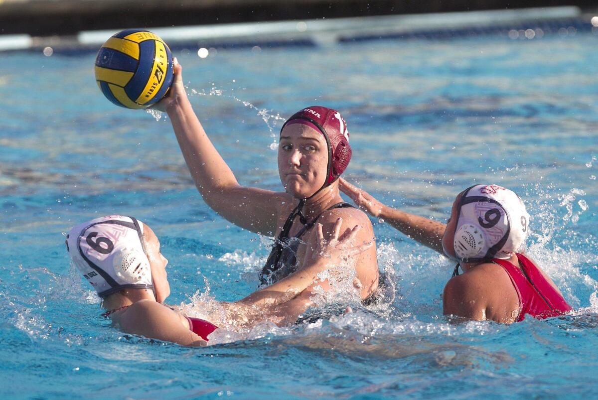 Laguna’s Aria Fischer turns to take a shot as Mater Dei defenders surround her during the Irvine SoCal Championships, won by Laguna Beach, on Saturday.