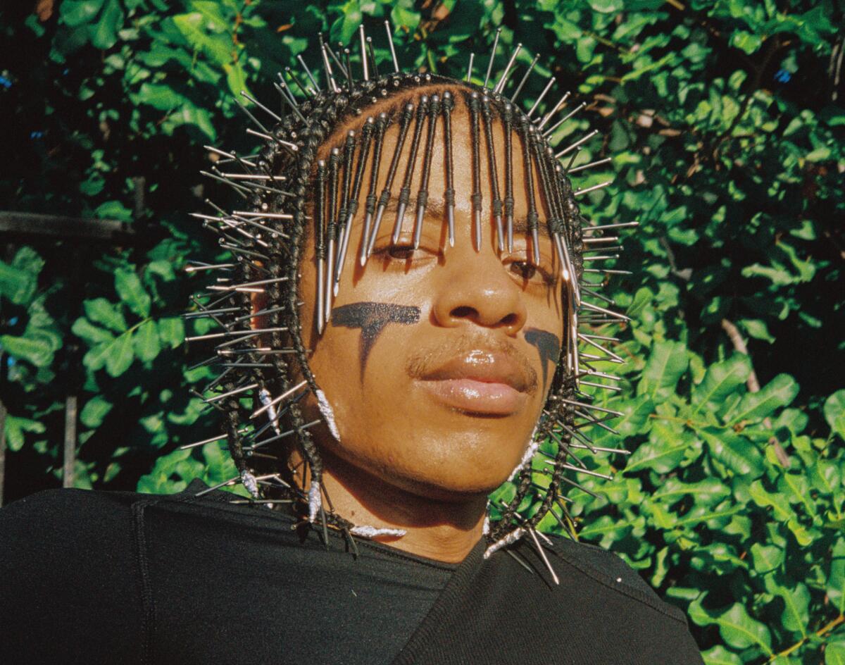 Teezo Touchdown has nails braided into his hair and greasepaint under his eyes.
