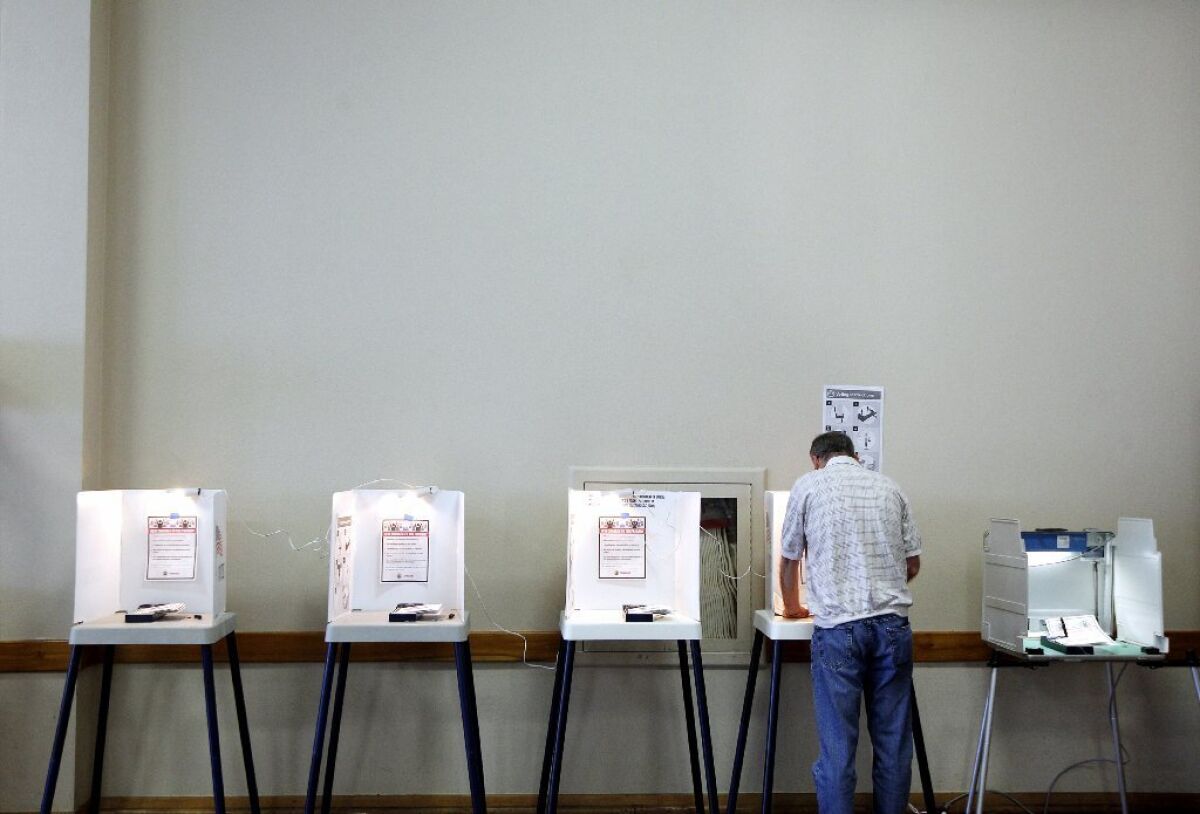 A lone voter fills out his ballot in the June 3 election at the International City Masonic Temple in Long Beach.