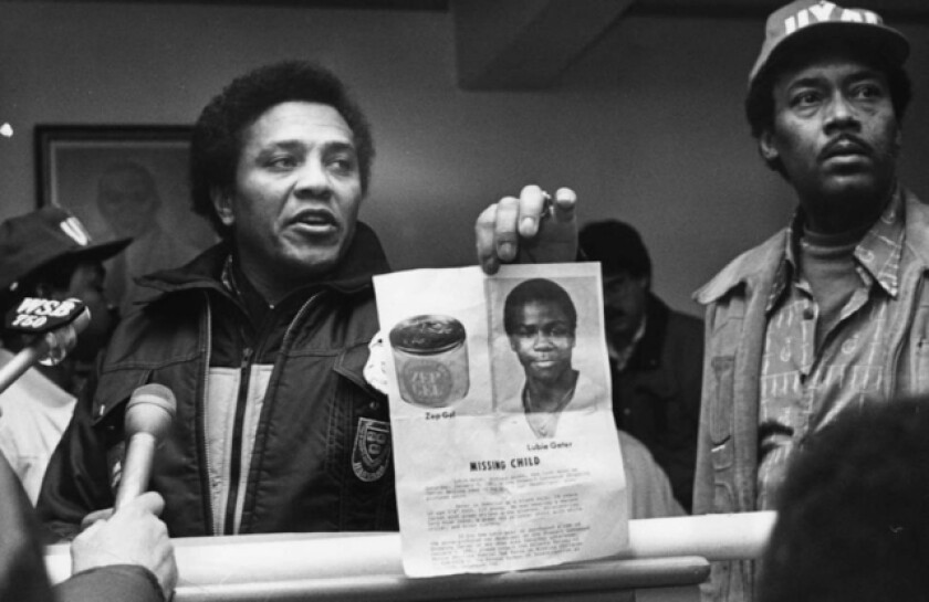 Eldrin Bell showing a photo of the missing Lubie Geter at a press conference in 1981.