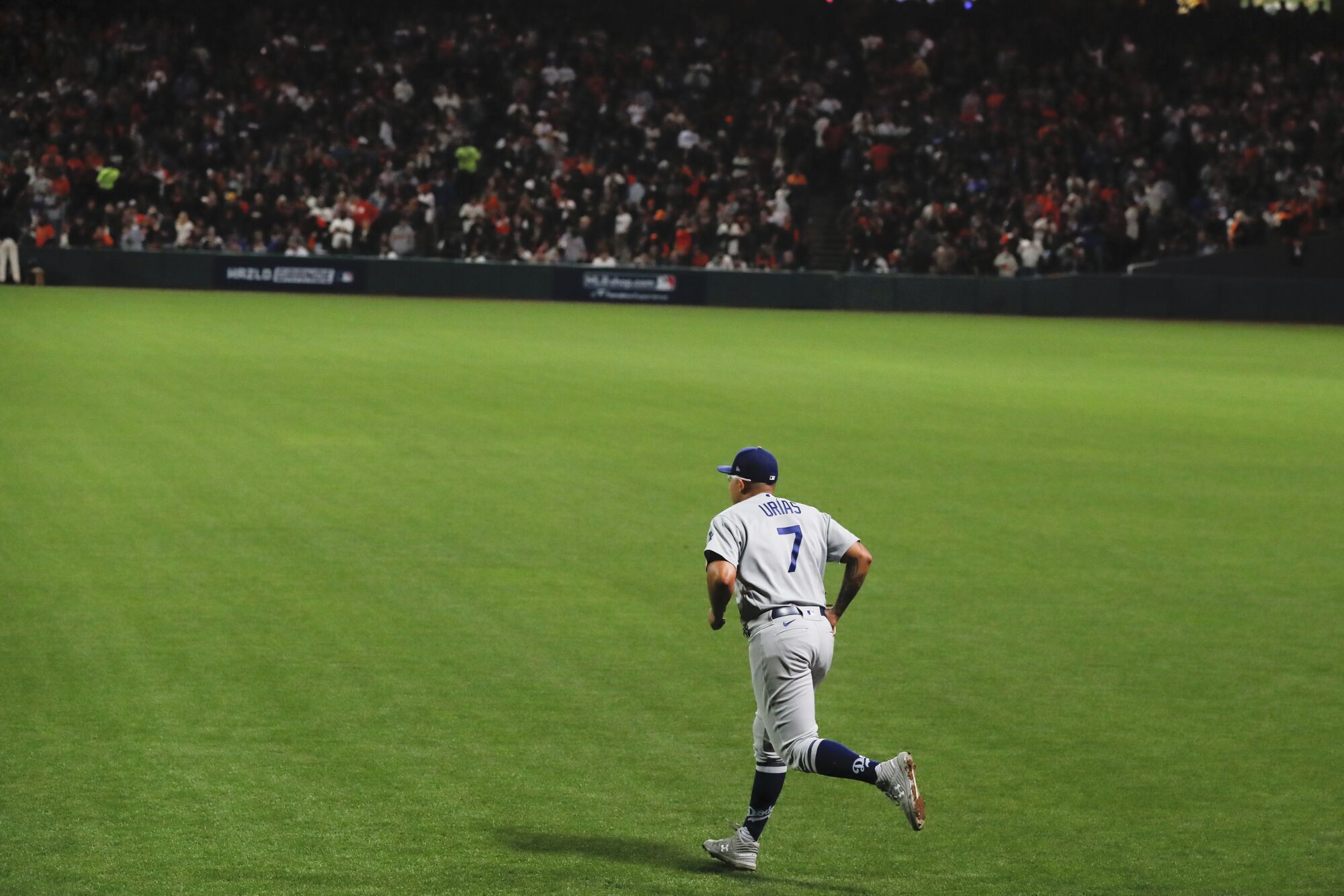 Dodgers pitcher Julio Urias runs onto the field