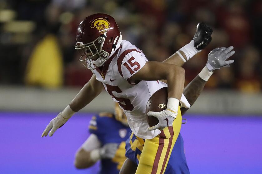 USC wide receiver Drake London leaps over California safety Trey Turner III.