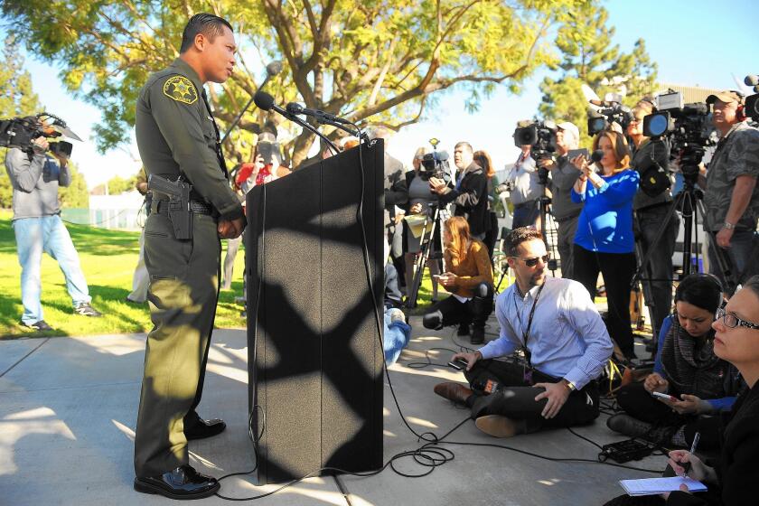 Phuong Nguyen, an Orange County Sheriff's deputy, speaks to the media in Vietnamese at a news conference in Santa Ana.