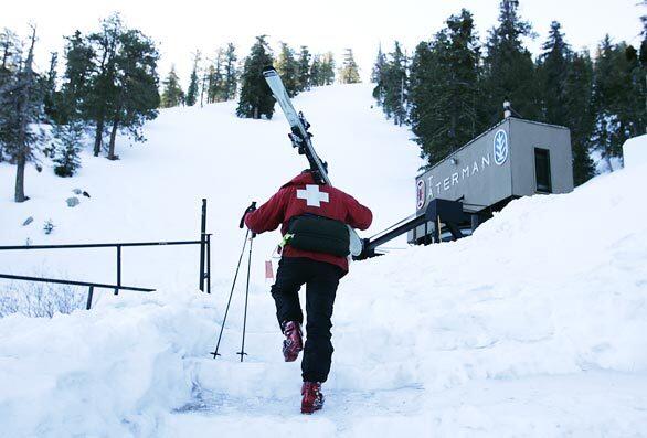 A member of the Ski Patrol arrives early to work at the Mt. Waterman ski resort before it opened Saturday.