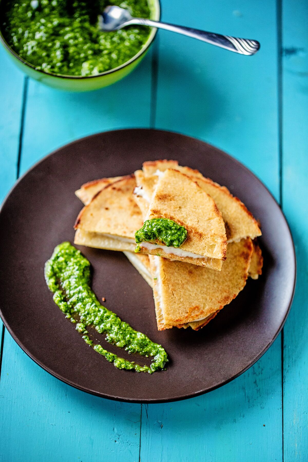 A stack of quesadillas made with cauliflower-corn tortillas sits on a plate.