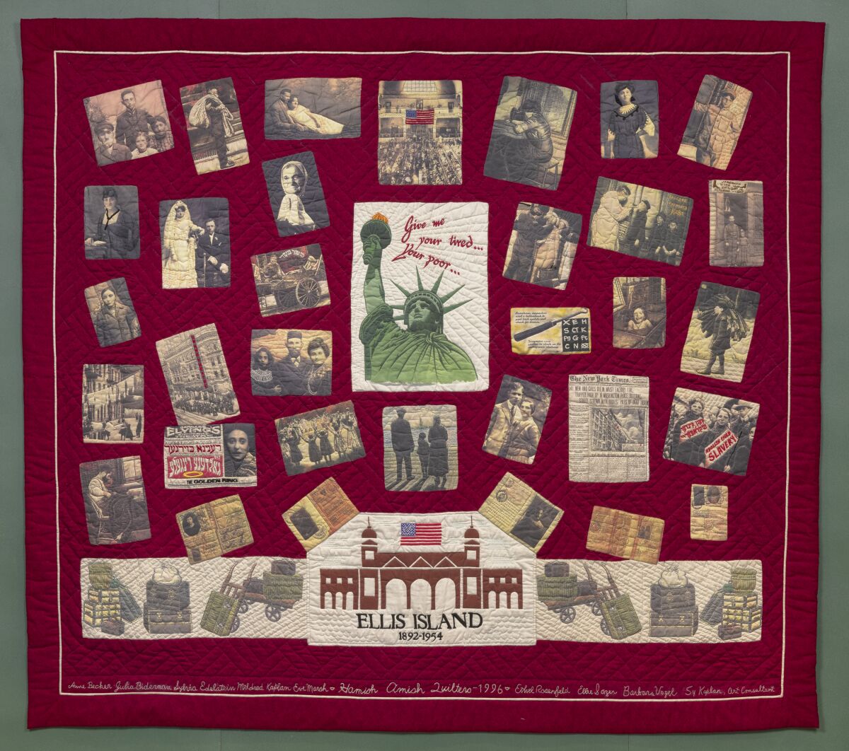A maroon quilt with many old photos on it