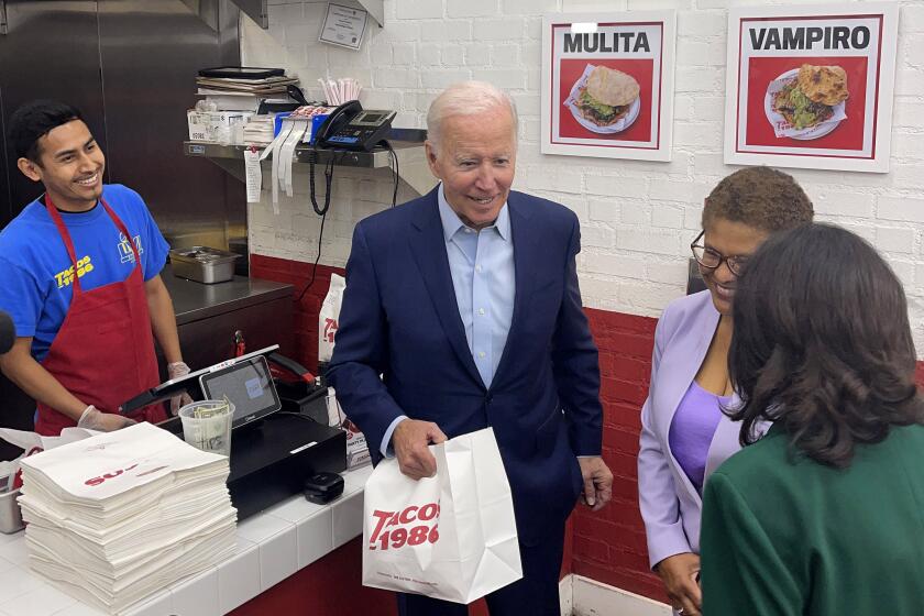 President Joe Biden with mayoral candidate Karen Bass, center, and L.A. County Supervisor Hilda Solis, right, made a stop at Tacos 1986 in Westwood on Thursday, Oct. 13, 2022.