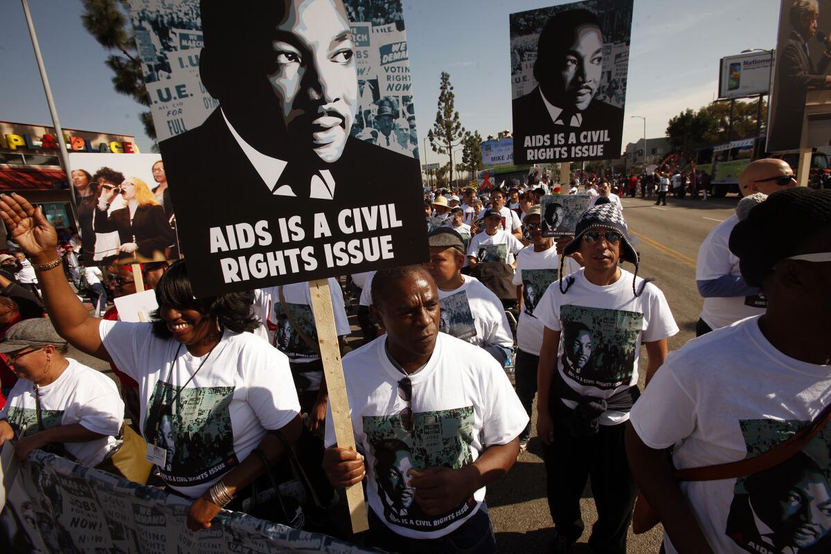 Terry Grant, center, marches with fellow members of the AIDS Healthcare Foundation who participated in the 30th Annual Kingdom Day Parade honoring the Rev. Martin Luther King Jr.